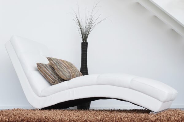 A White Color Recliner With Two Pillows